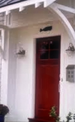 Fake proof-of-delivery photo of a red front door submitted by a driver